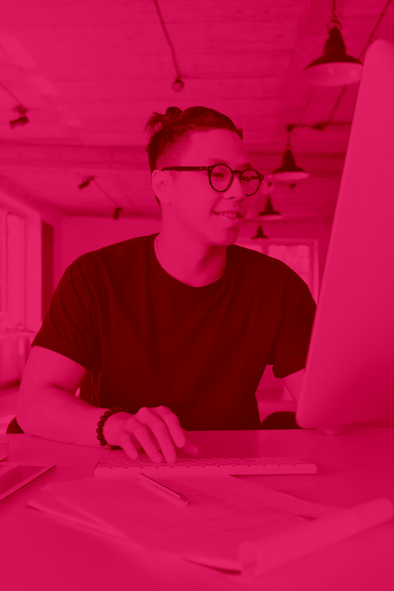 Web developer in a casual setting, actively coding on a laptop, representing website development and digital solutions.